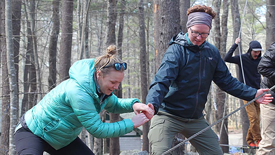 people outdoors on a ropes challenge